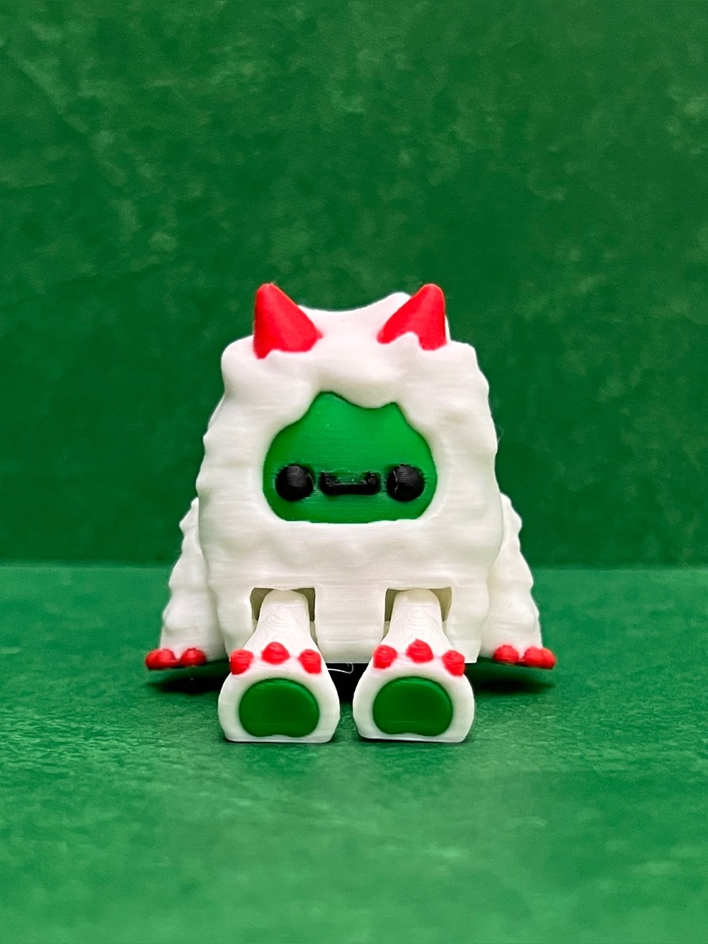3D Printed White Yeti Figurine with Red Horns